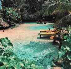Calm water and shaded shoreline at Mahogany Beach, a quiet spot outside Ocho Rios