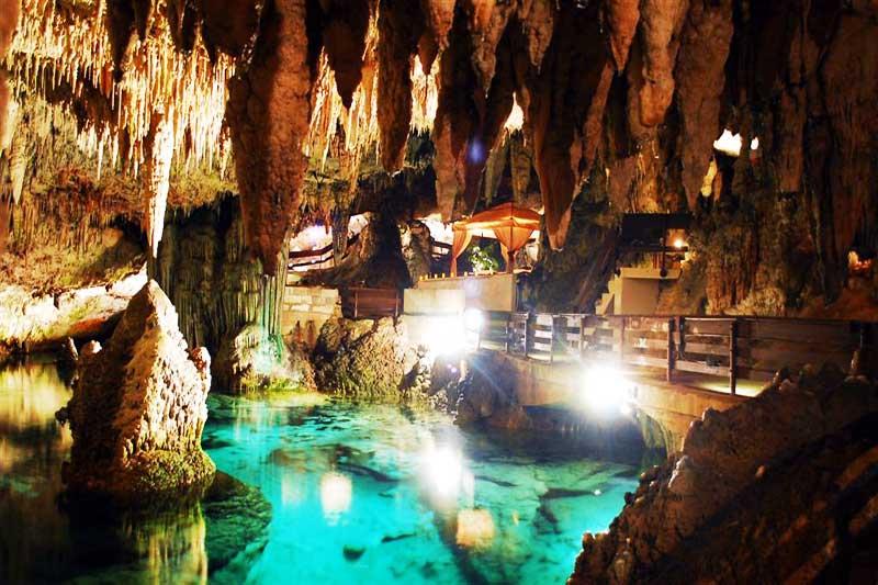 Green Grotto Caves Jamaica - underground lake stalactites illuminated teal water Discovery Bay