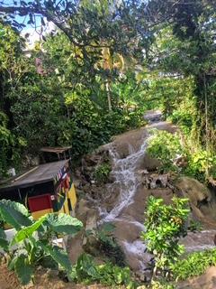 Small waterfall flowing into the ocean at Little Dunn's River, a secret beach near Ocho Rios