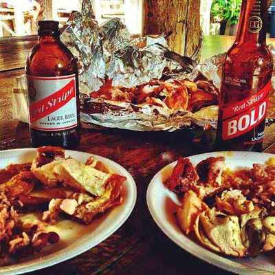 Plates of jerk chicken and pork served at Scotchies Jerk Centre in Drax Hall, Jamaica